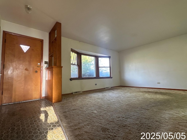 carpeted entryway featuring baseboards and visible vents