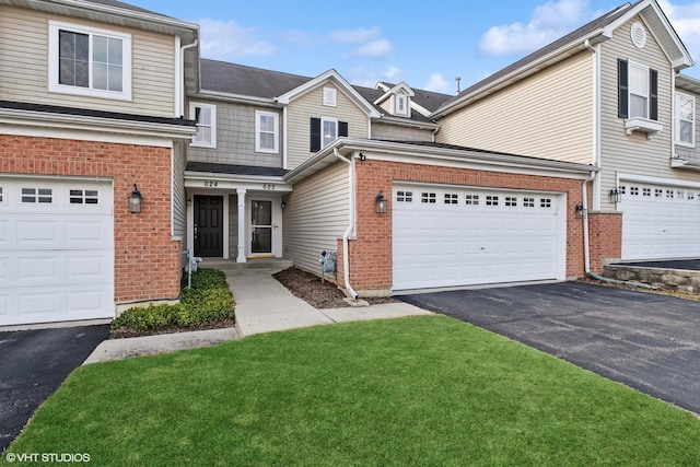 view of front of property featuring driveway, brick siding, and a front yard