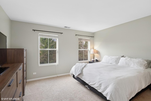 bedroom featuring multiple windows, baseboards, and carpet flooring