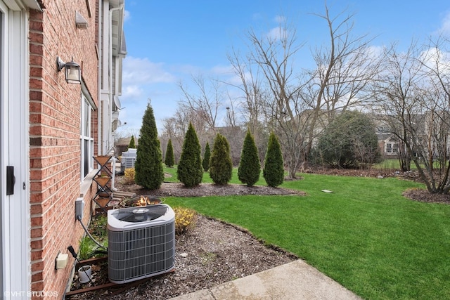 view of green lawn with cooling unit