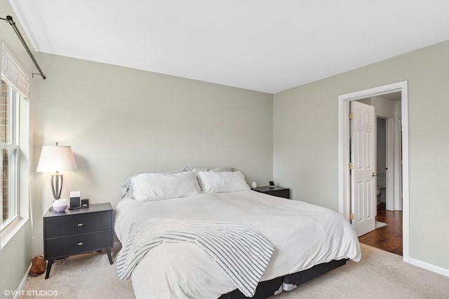 carpeted bedroom featuring baseboards