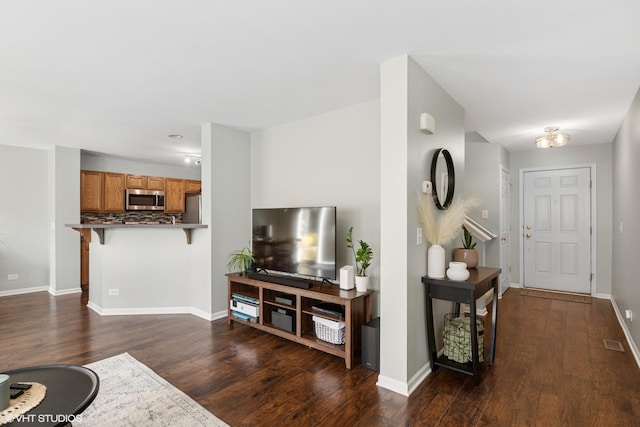 living area with dark wood-style floors and baseboards