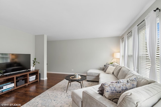 living room featuring wood finished floors and baseboards