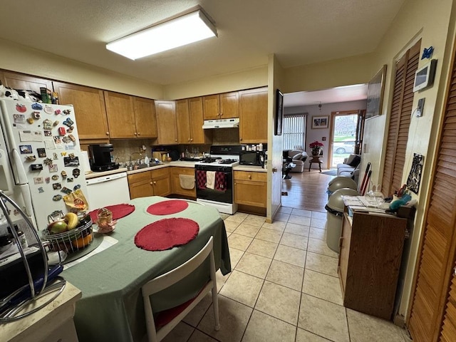 5712 Crestwood Rd, Matteson, IL 60443 - kitchen featuring white appliances, under cabinet range hood, light countertops, and light tile patterned flooring