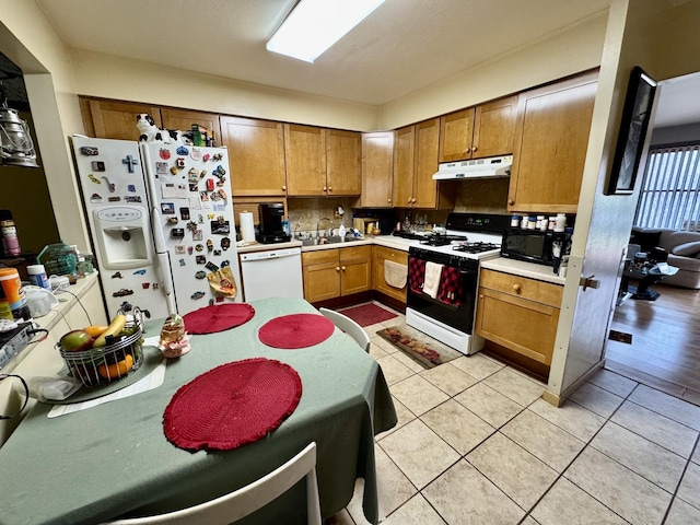 5712 Crestwood Rd, Matteson, IL 60443 - kitchen with white appliances, under cabinet range hood, light countertops, and brown cabinetry