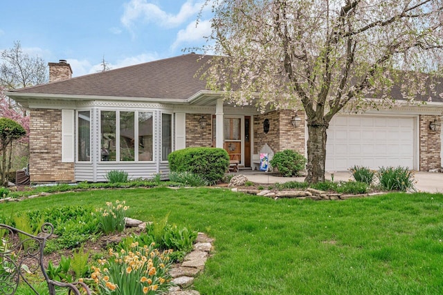 view of front facade featuring a chimney, brick siding, and a front lawn