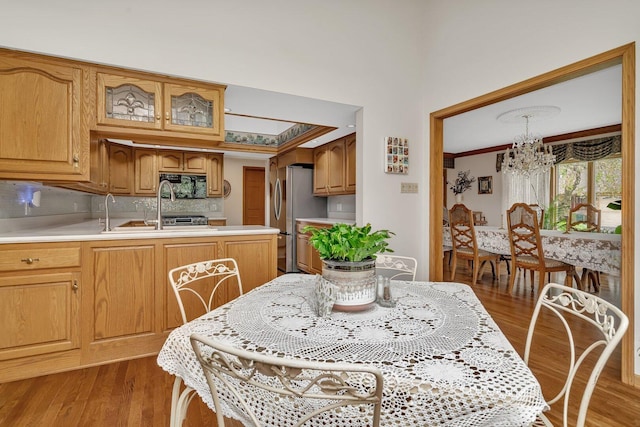 dining room featuring a chandelier, light wood-type flooring, and crown molding