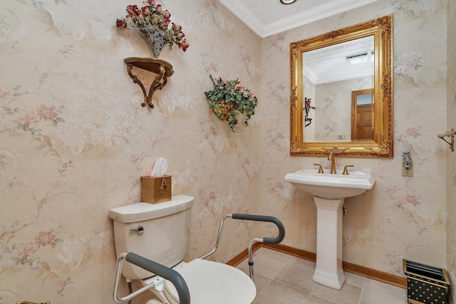 half bathroom with ornamental molding, toilet, baseboards, tile patterned flooring, and a sink