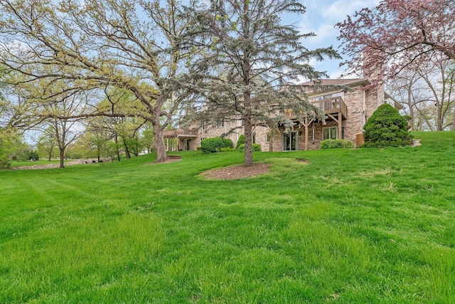 view of green lawn featuring a deck