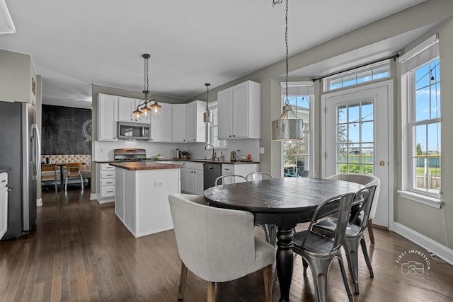 2027 Heatherstone Ct, Plainfield, IL 60586 - dining room featuring dark wood-style flooring and baseboards