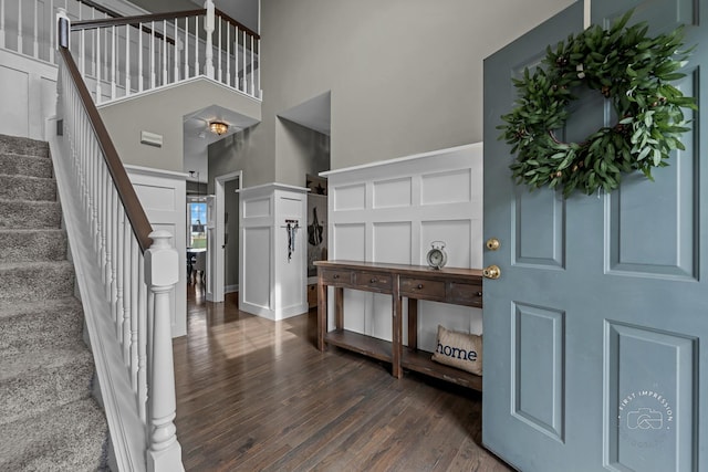 2027 Heatherstone Ct, Plainfield, IL 60586 - entryway featuring dark wood-type flooring, stairs, a high ceiling, and a decorative wall