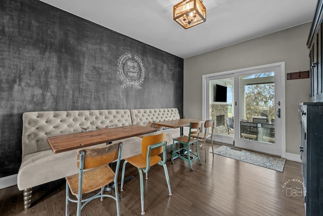 2027 Heatherstone Ct, Plainfield, IL 60586 - dining room featuring wood finished floors, breakfast area, a stone fireplace, and baseboards