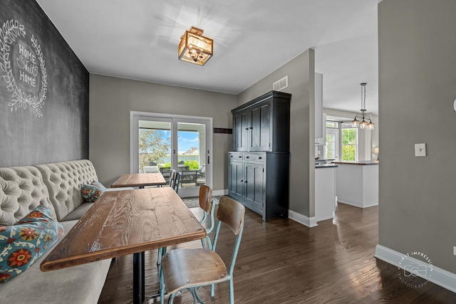 2027 Heatherstone Ct, Plainfield, IL 60586 - dining area featuring a chandelier, dark wood-style floors, and baseboards
