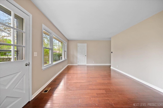 16 Circle Dr E, Montgomery, IL 60538 - empty room with baseboards, visible vents, and wood finished floors