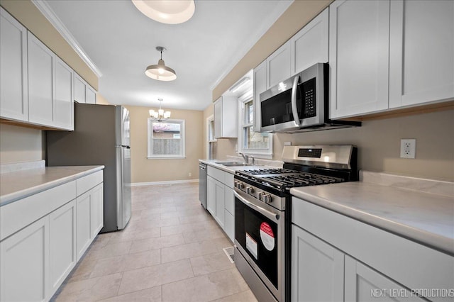 16 Circle Dr E, Montgomery, IL 60538 - kitchen featuring stainless steel appliances, light countertops, baseboards, white cabinets, and ornamental molding