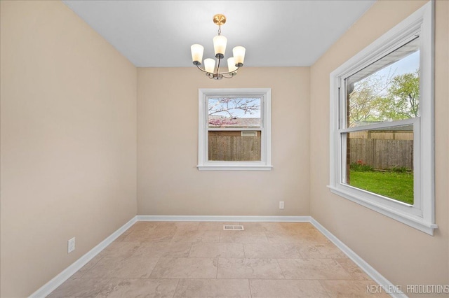 16 Circle Dr E, Montgomery, IL 60538 - spare room featuring a chandelier, baseboards, and visible vents