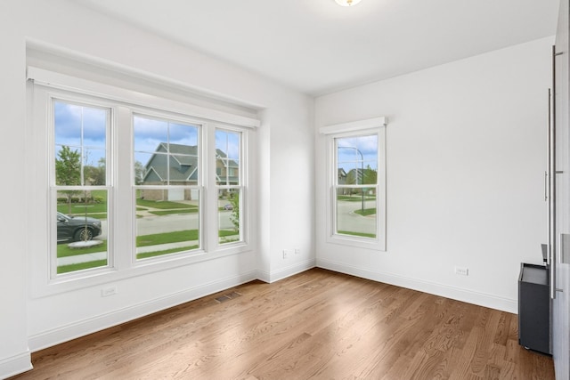 9014 Gloucester Rd, Woodridge, IL 60517 - spare room with healthy amount of natural light, wood finished floors, and baseboards