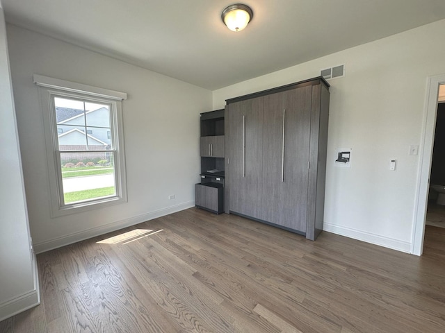 9014 Gloucester Rd, Woodridge, IL 60517 - unfurnished bedroom with light wood-type flooring, baseboards, and a closet