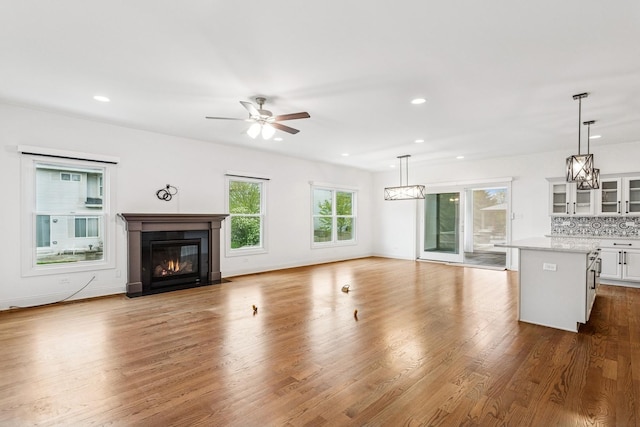 9014 Gloucester Rd, Woodridge, IL 60517 - unfurnished living room featuring a fireplace with flush hearth, ceiling fan, recessed lighting, dark wood-type flooring, and baseboards
