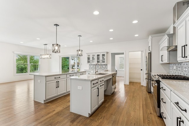 9014 Gloucester Rd, Woodridge, IL 60517 - kitchen with appliances with stainless steel finishes, a center island with sink, a sink, tasteful backsplash, and recessed lighting