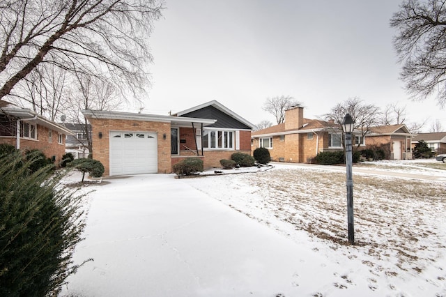 ranch-style house featuring concrete driveway, brick siding, and a garage
