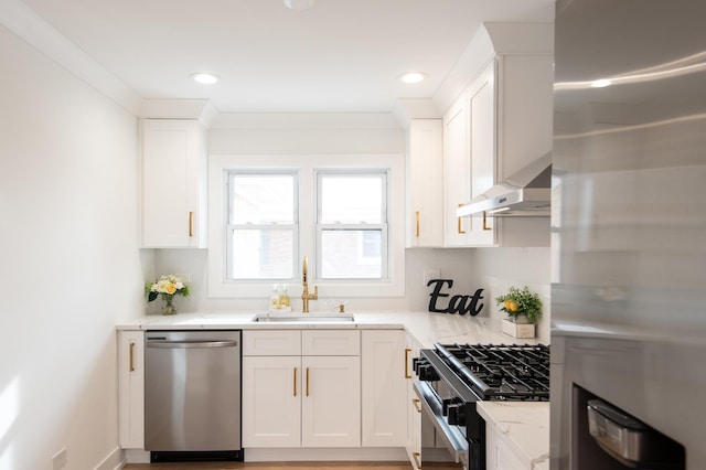 kitchen with a sink, white cabinetry, backsplash, under cabinet range hood, and appliances with stainless steel finishes