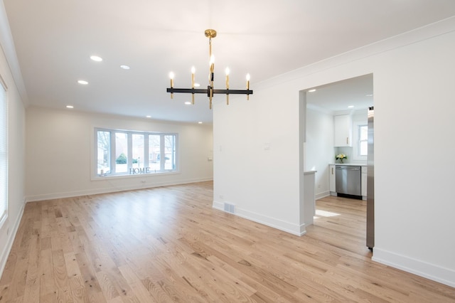 interior space with crown molding, a wealth of natural light, and a chandelier
