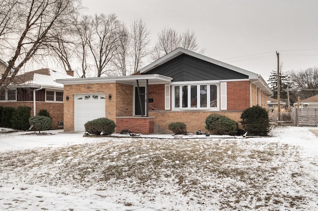 single story home with fence, an attached garage, and brick siding