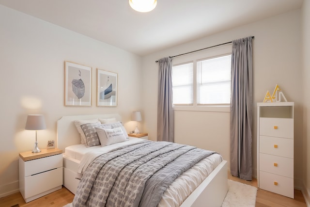 bedroom featuring baseboards and light wood-style floors
