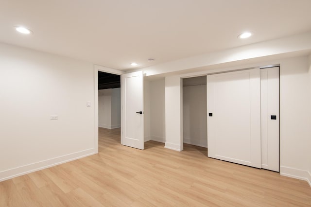 unfurnished bedroom featuring baseboards, light wood-type flooring, and recessed lighting
