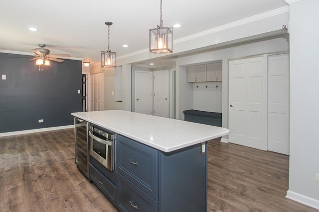 1425 Meghan Ave, Algonquin, IL 60102 - kitchen with crown molding, blue cabinetry, ceiling fan, dark wood finished floors, and hanging light fixtures