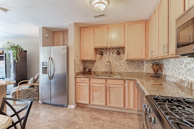 50 N Bokelman Ave Unit 233, Roselle, IL 60172 - kitchen with stainless steel appliances, light brown cabinets, a sink, light stone countertops, and tasteful backsplash
