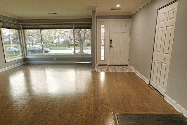 10145 Lawrence Ct, Oak Lawn, IL 60453 - foyer entrance with baseboards, ornamental molding, visible vents, and dark wood-type flooring