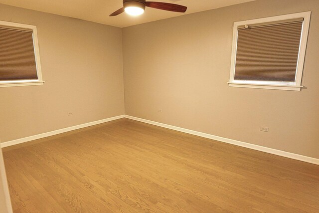 10145 Lawrence Ct, Oak Lawn, IL 60453 - empty room featuring wood finished floors, baseboards, and ceiling fan