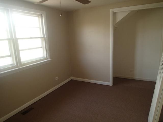 unfurnished bedroom featuring baseboards, visible vents, and carpet