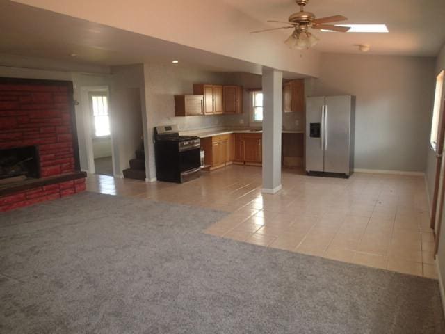 kitchen with ceiling fan, light tile patterned floors, plenty of natural light, and appliances with stainless steel finishes