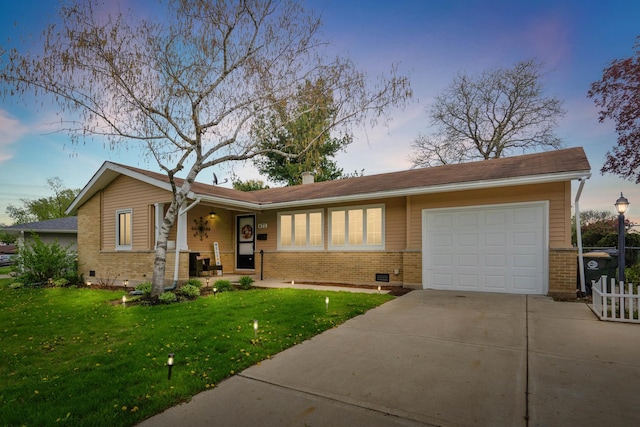 ranch-style house featuring concrete driveway, a yard, brick siding, and an attached garage