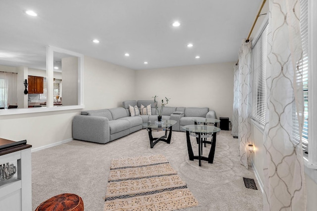 living room featuring light carpet, baseboards, and recessed lighting