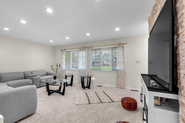 carpeted living area featuring baseboards, visible vents, and recessed lighting