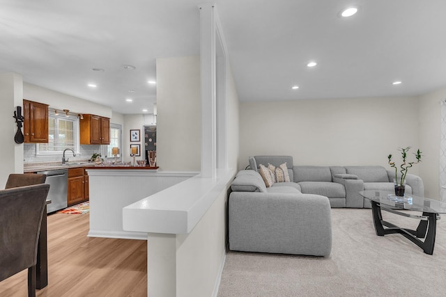living room with light wood finished floors, baseboards, and recessed lighting