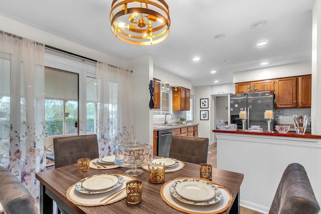 dining room featuring an inviting chandelier, light wood-style floors, and recessed lighting