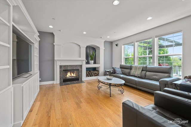 9692 Baumgartner St, Huntley, IL 60142 - living room featuring a tile fireplace, light wood-style floors, recessed lighting, and built in features