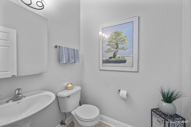 9692 Baumgartner St, Huntley, IL 60142 - bathroom with a sink, baseboards, and toilet