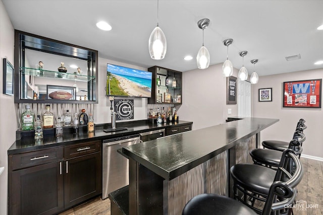 9692 Baumgartner St, Huntley, IL 60142 - indoor wet bar featuring stainless steel dishwasher, light wood-type flooring, recessed lighting, and pendant lighting