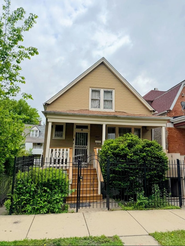 6427 S Winchester Ave, Chicago, IL 60636 - bungalow featuring a fenced front yard, a porch, and a gate
