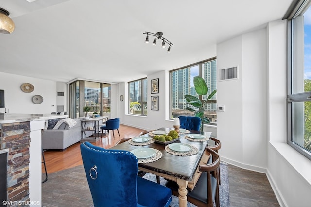 dining area featuring wood finished floors and baseboards