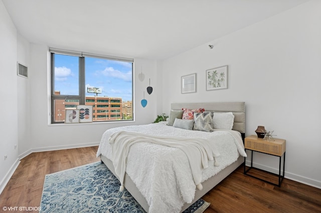 bedroom featuring wood finished floors and baseboards