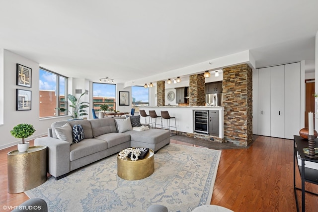 living area with wood finished floors and beverage cooler