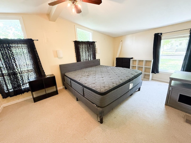 carpeted bedroom with baseboards, multiple windows, and ceiling fan