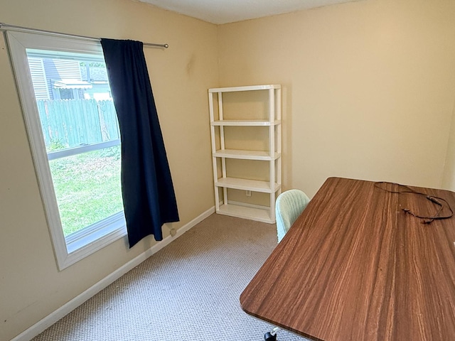 carpeted office featuring baseboards
